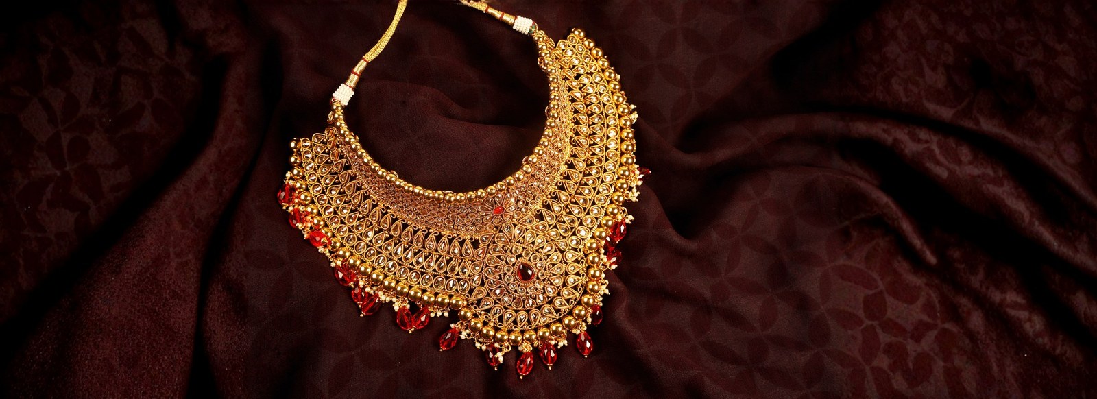 Gold bridal choker with kundan and ruby drops — Ramanand Jewellers